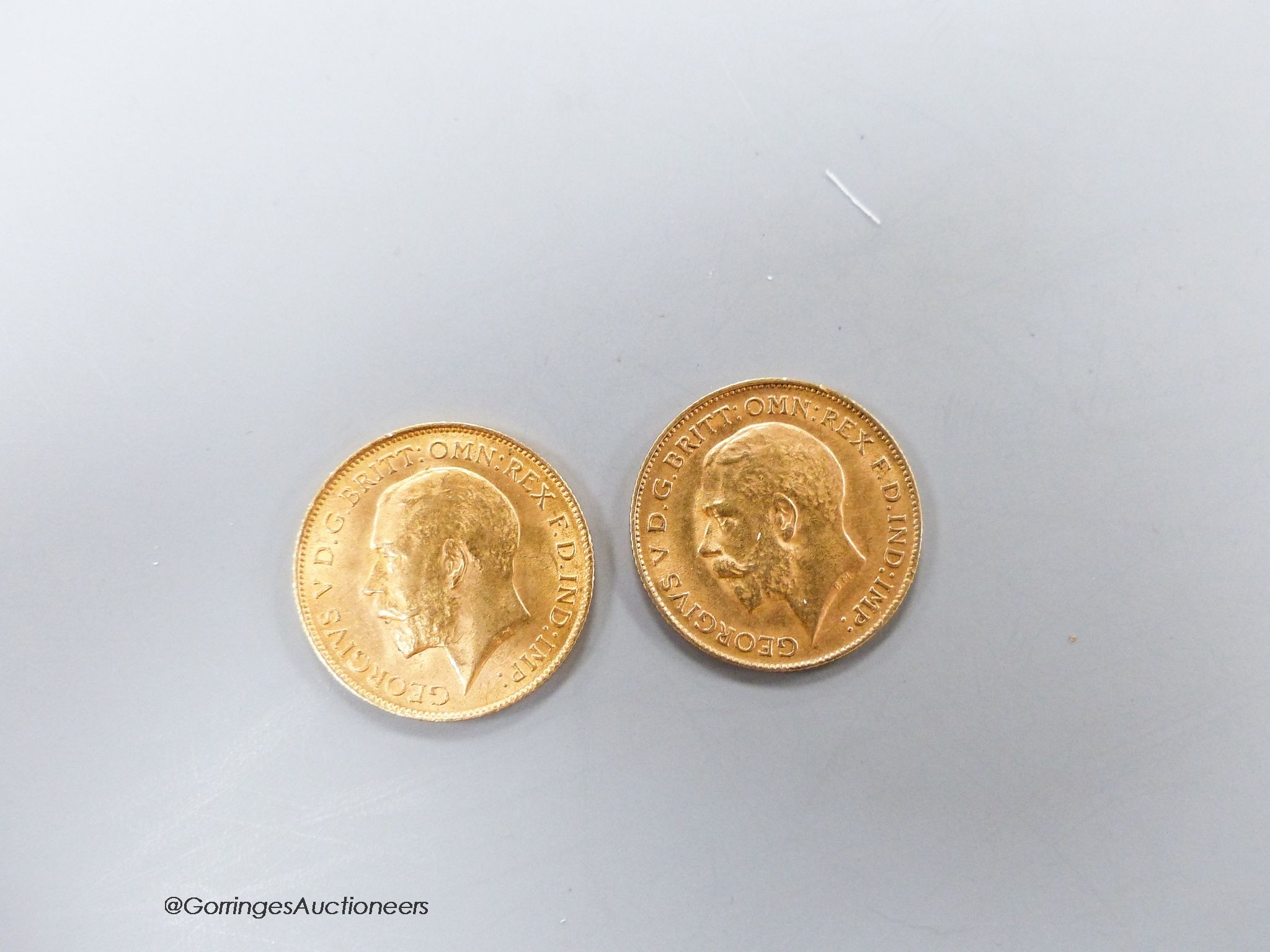 Two George V gold half sovereigns, 1913 & 1914 and an Edwardian silver sovereign case.